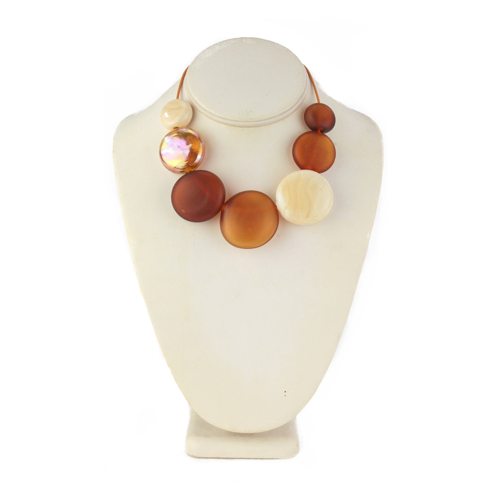 A handcrafted necklace featuring seven hollow hand-blown glass beads in amber, ivory, and gold hues, strung on adjustable leather for a versatile, elegant look.