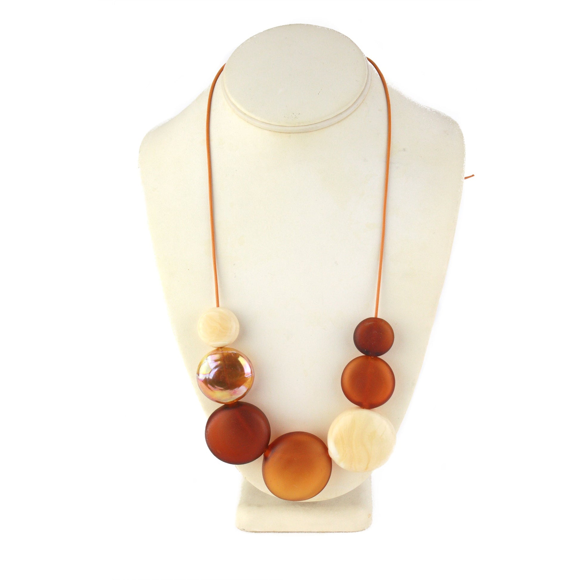 A handcrafted necklace featuring seven hollow hand-blown glass beads in amber, ivory, and gold hues, strung on adjustable leather for a versatile, elegant look.