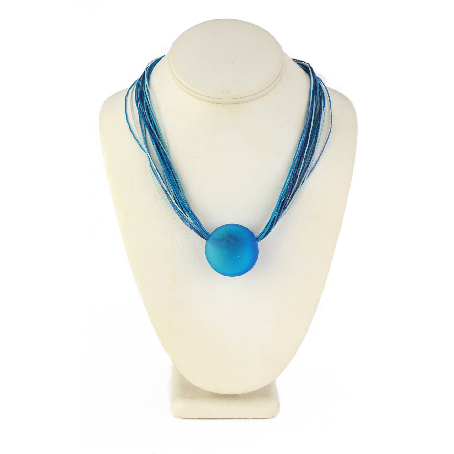 A vibrant necklace featuring a hand-blown blue glass focal bead strung on multi-strand waxed cord in coordinating blue tones. Finished with a sterling silver hook-and-loop clasp, this elegant piece adds a bold pop of color to any outfit.