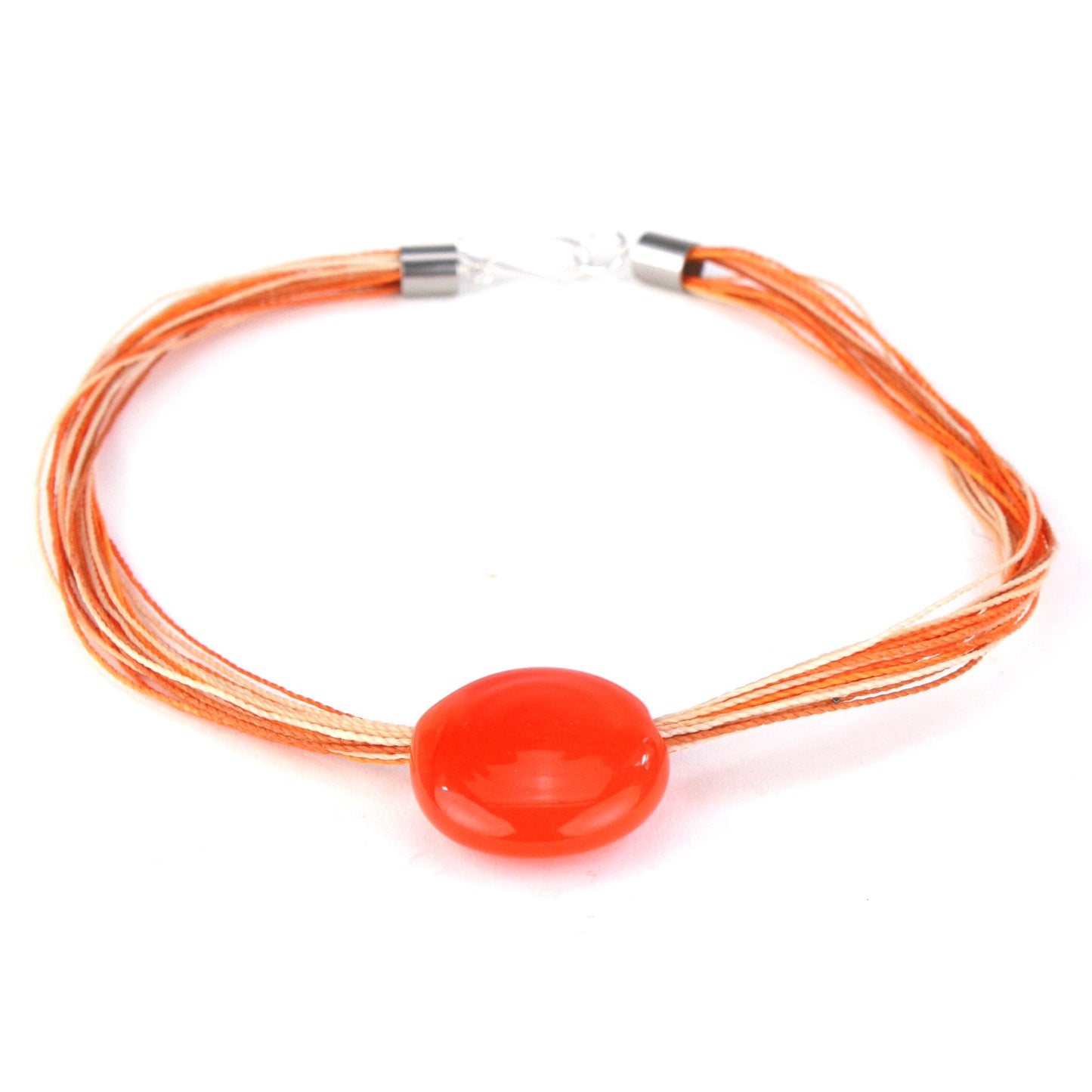 A bold necklace featuring a hand-blown orange glass focal bead strung on multi-strand waxed cord in vibrant shades of orange, cream, and beige. Finished with a sterling silver hook-and-loop clasp, this piece adds a pop of bright color to any outfit.