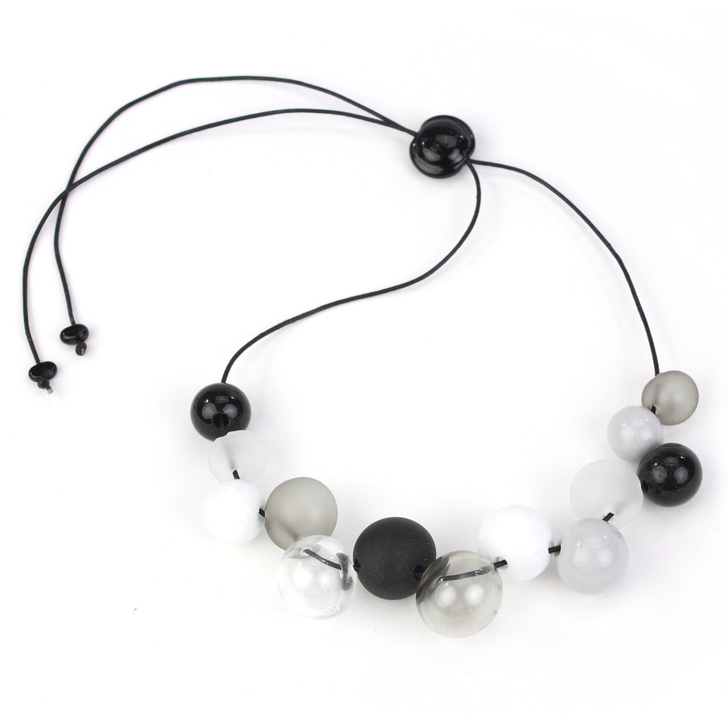 Elegant Offset Bolla Necklace with black, white, and gray hand-blown glass beads. Adjustable from 36" to choker length on fine leather. Perfect for any outfit!