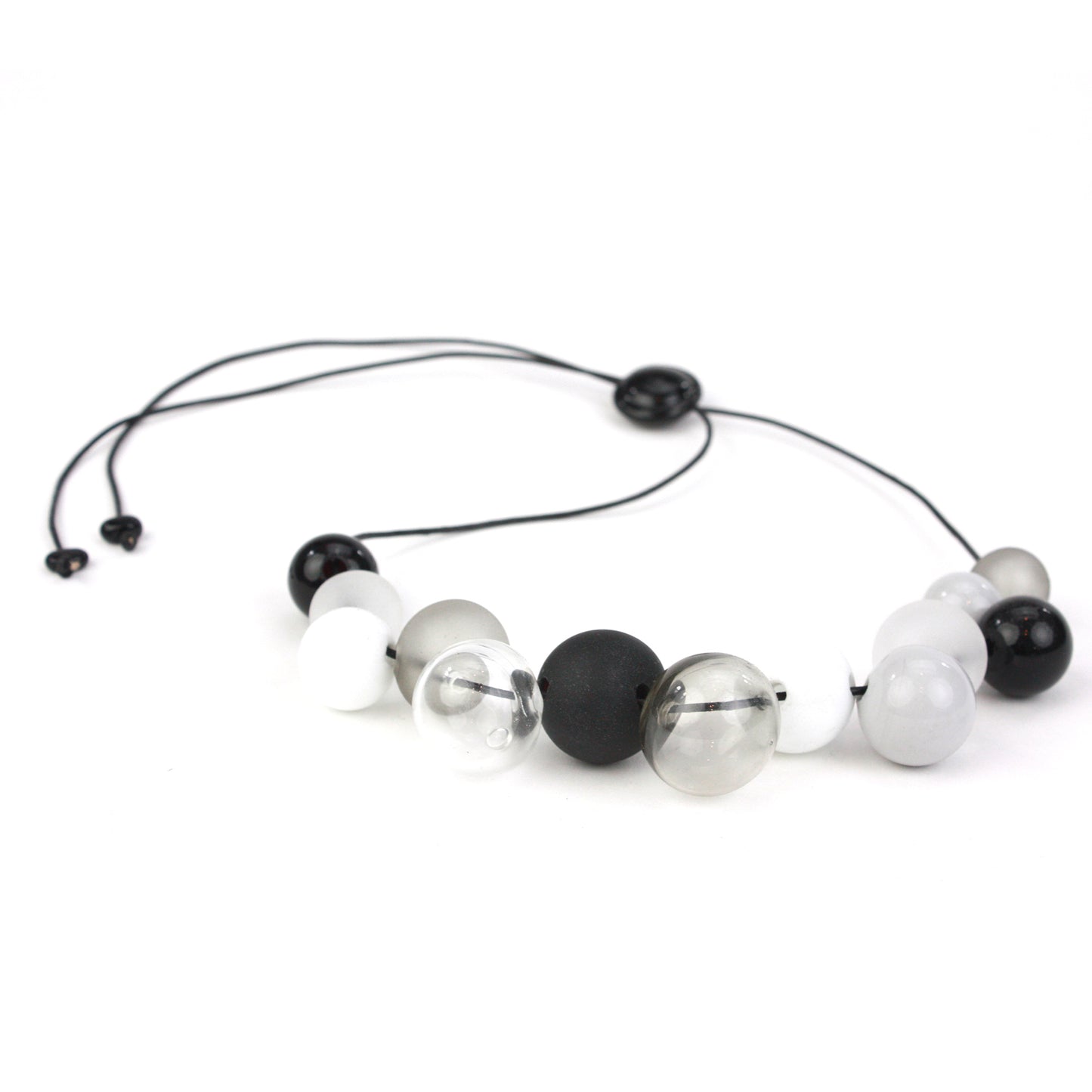 Elegant Offset Bolla Necklace with black, white, and gray hand-blown glass beads. Adjustable from 36" to choker length on fine leather. Perfect for any outfit!