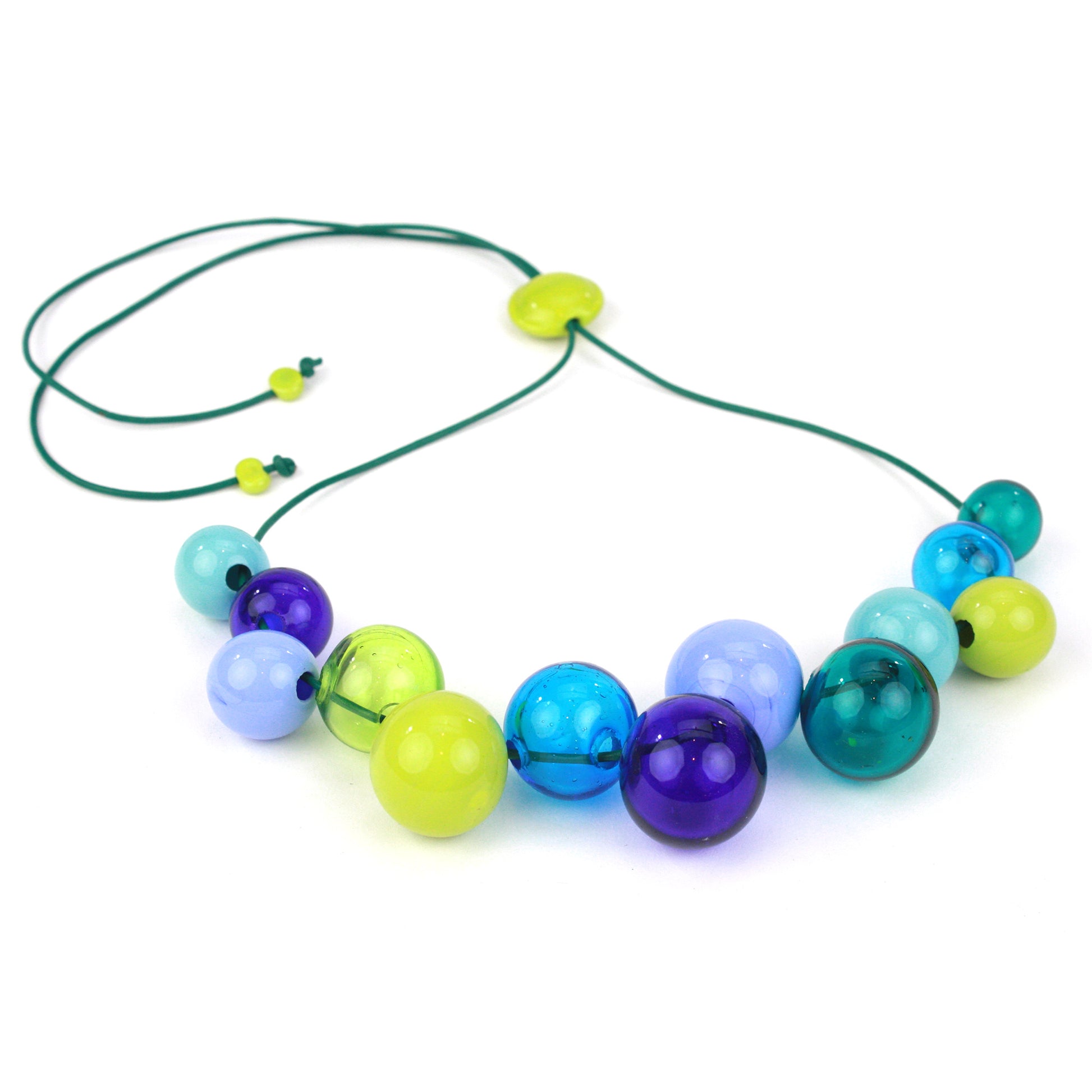 Hand-blown glass bead Offset Bolla Necklace in vivid blue, teal, and green hues. Adjustable length from 36" to choker on fine green leather. Bold and stylish!