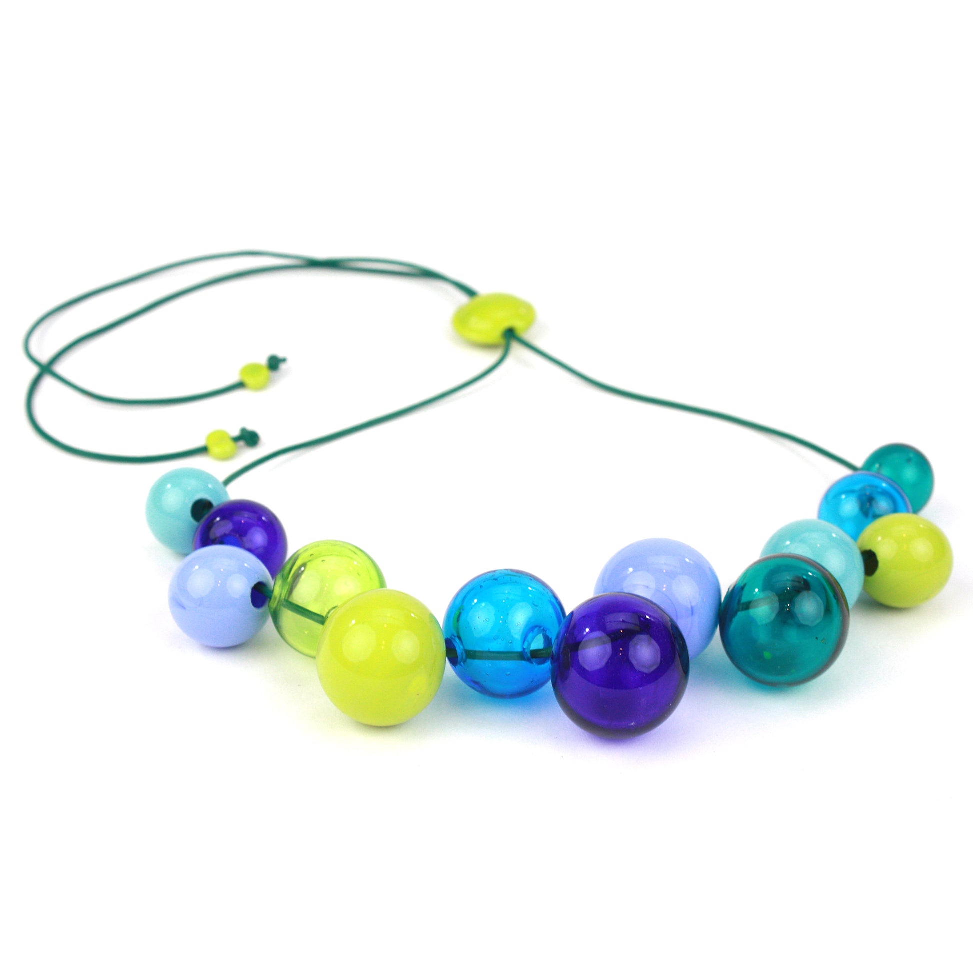 Hand-blown glass bead Offset Bolla Necklace in vivid blue, teal, and green hues. Adjustable length from 36" to choker on fine green leather. Bold and stylish!