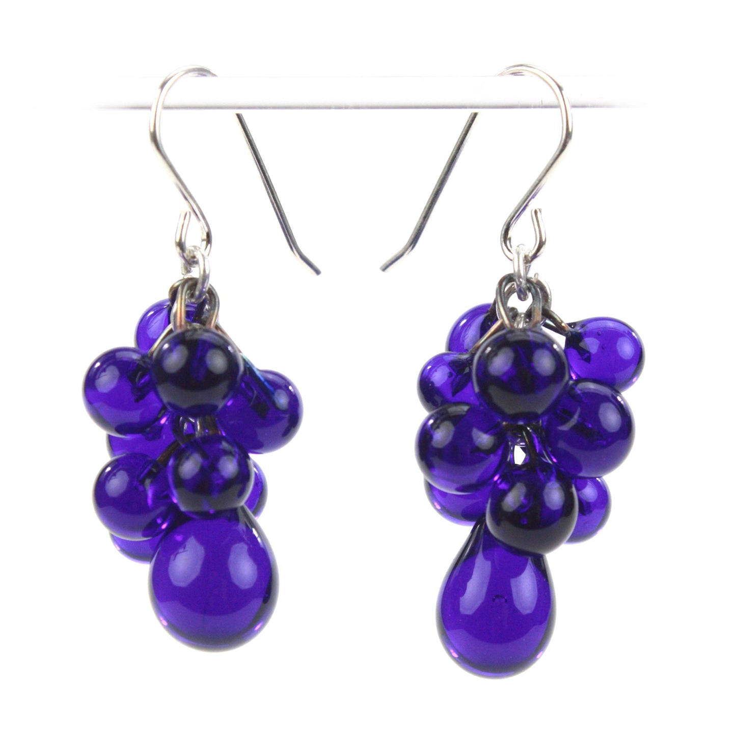 Cobalt Cluster Earrings with cascading handmade glass beads in deep amethyst hues, teardrop accents, and sterling silver ear wires for a bold, luxurious look.