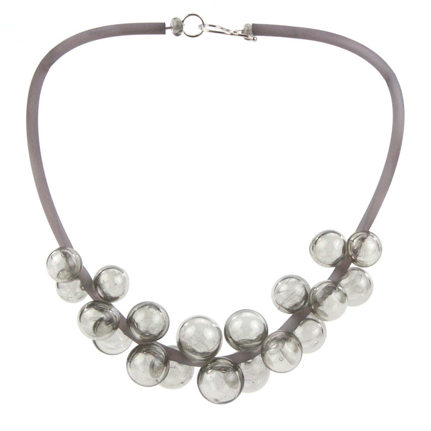 A smoky gray Chroma necklace featuring clustered handblown glass beads strung on steel wire and threaded through a hand-dyed silicone cord with a sterling silver clasp.