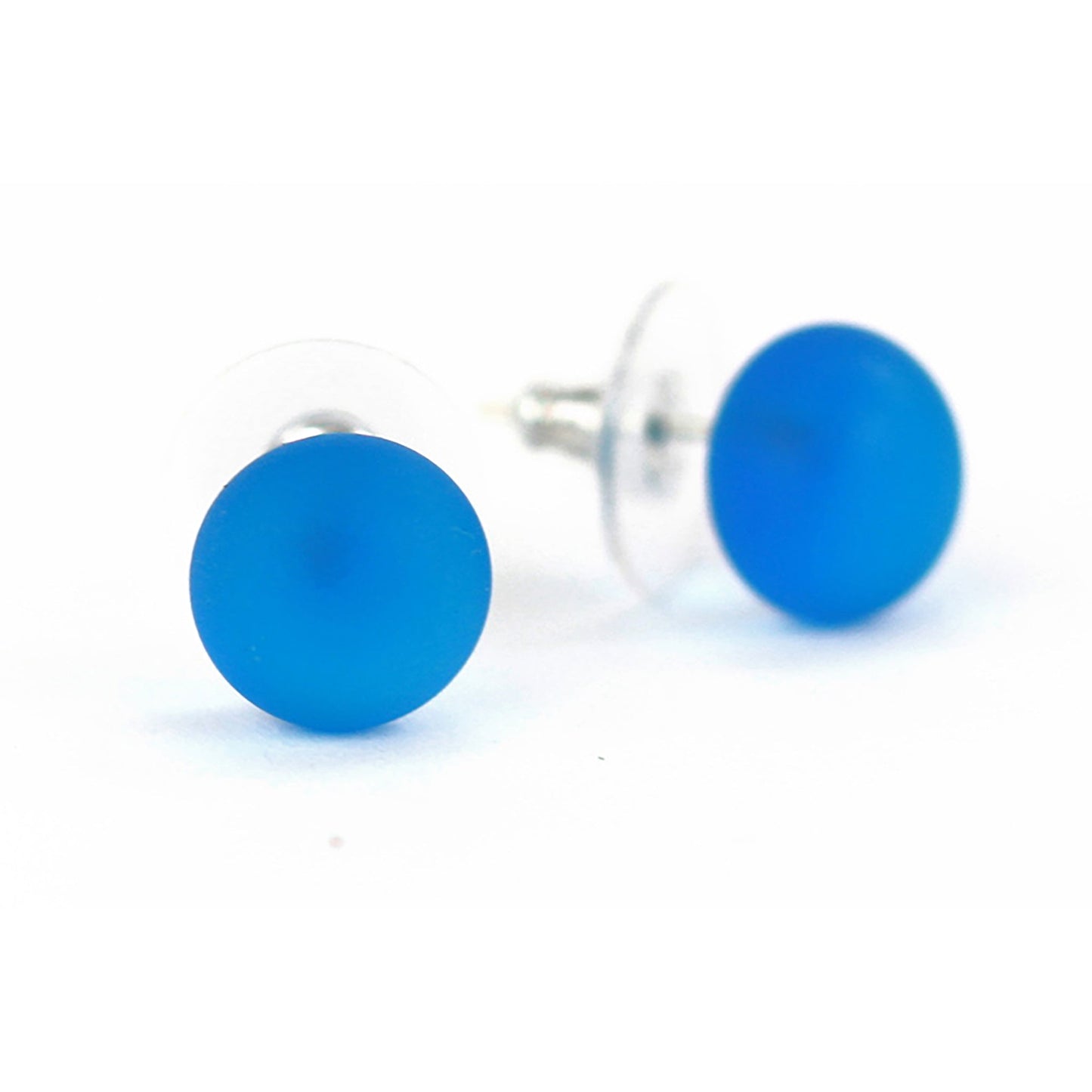 Pair of sandblasted aqua glass stud earrings with frosted matte finish and sterling silver posts, paired with clear earring backs.