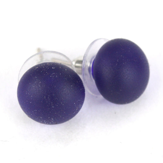 Pair of sandblasted cobalt blue glass stud earrings with frosted matte finish and sterling silver posts, paired with clear earring backs.