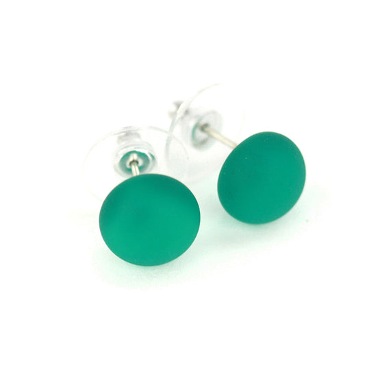 Small frosted teal glass stud earrings with a matte finish and sterling silver posts, paired with clear earring backs.