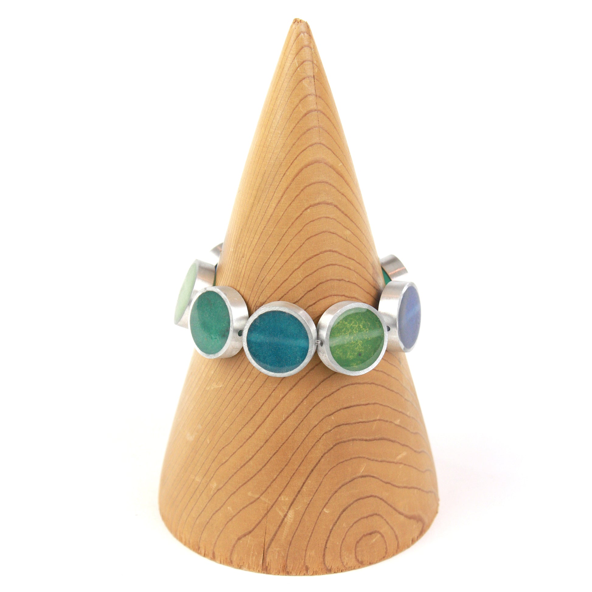 Resinique Single Circle Bracelet with a vibrant mix of blue and green eco-resin discs set in salvaged aluminum, strung on elastic for comfort and style.