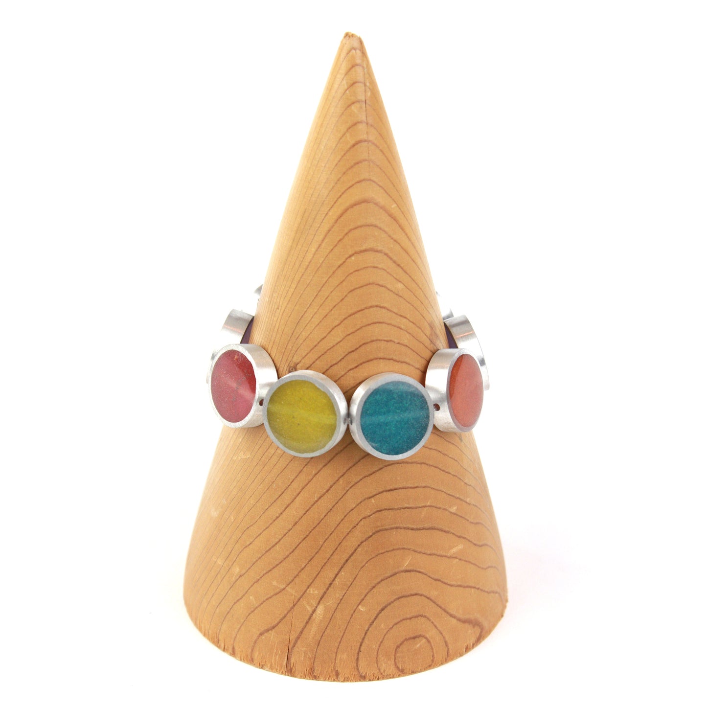 Resinique Rainbow Circle Bracelet featuring multicolored eco-resin discs (red, orange, yellow, green, blue, purple) set in salvaged aluminum, strung on elastic.