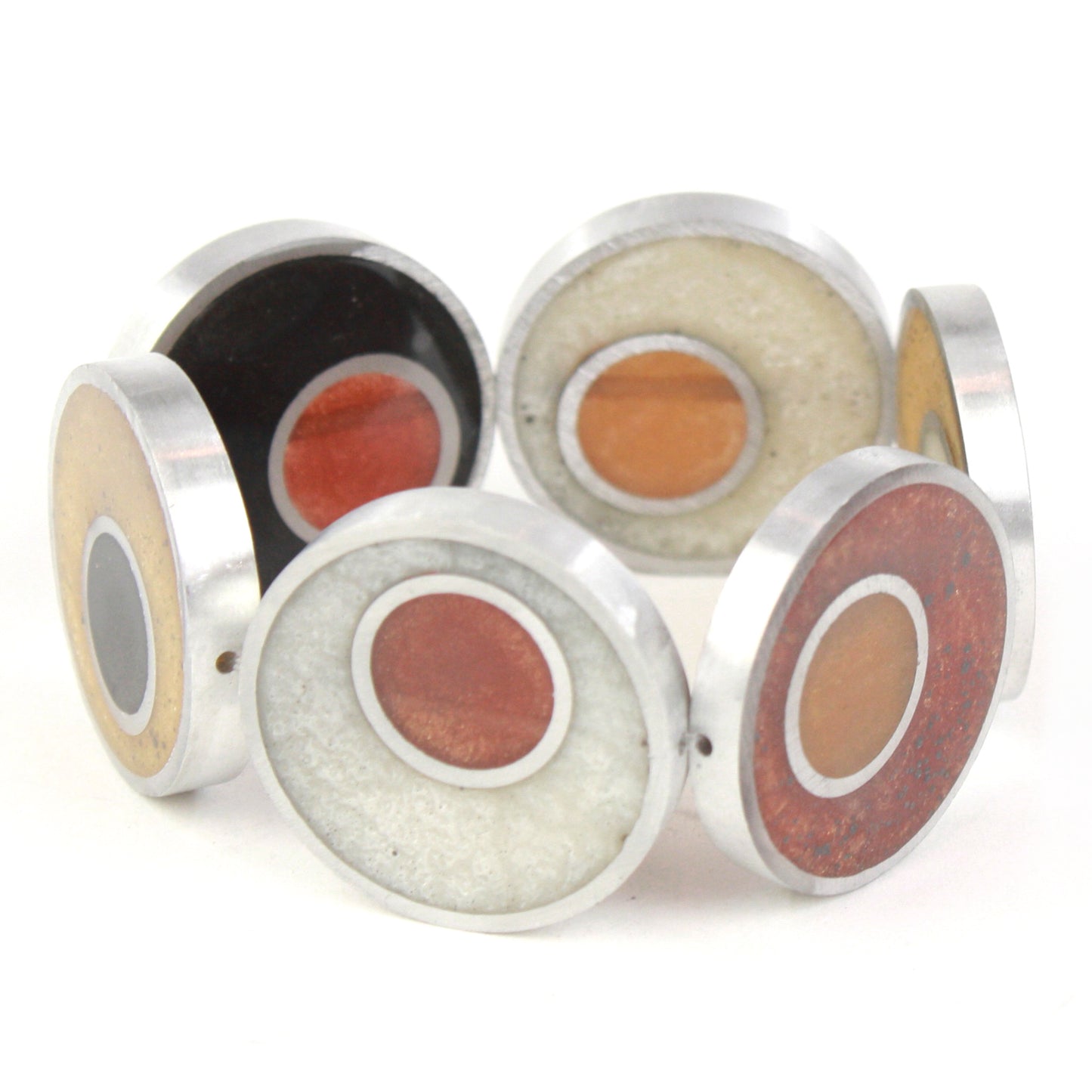 Resinique Double Circle Bracelet featuring layered circles of eco-resin in warm tones, set in salvaged aluminum and strung on an elastic band.