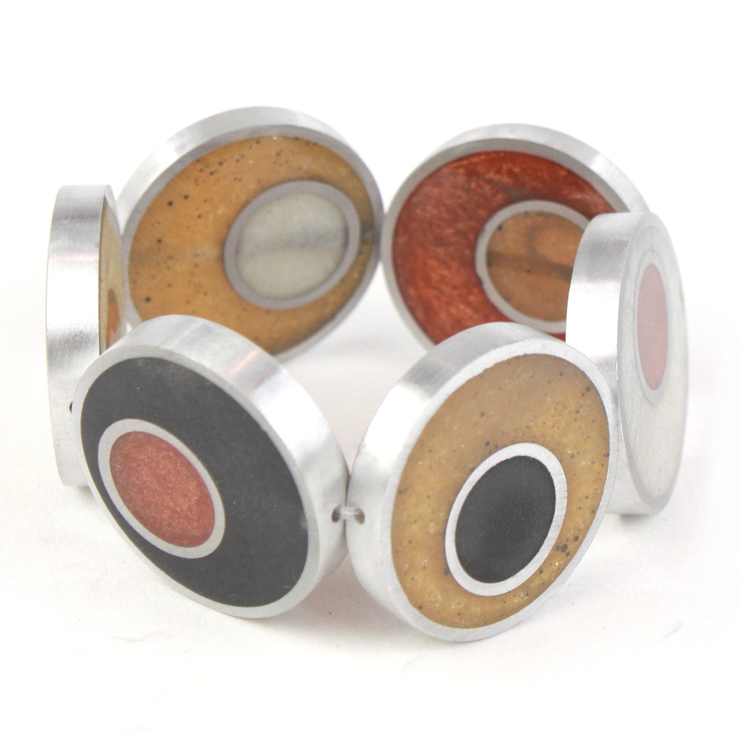 Resinique Double Circle Bracelet featuring layered circles of eco-resin in warm tones, set in salvaged aluminum and strung on an elastic band.