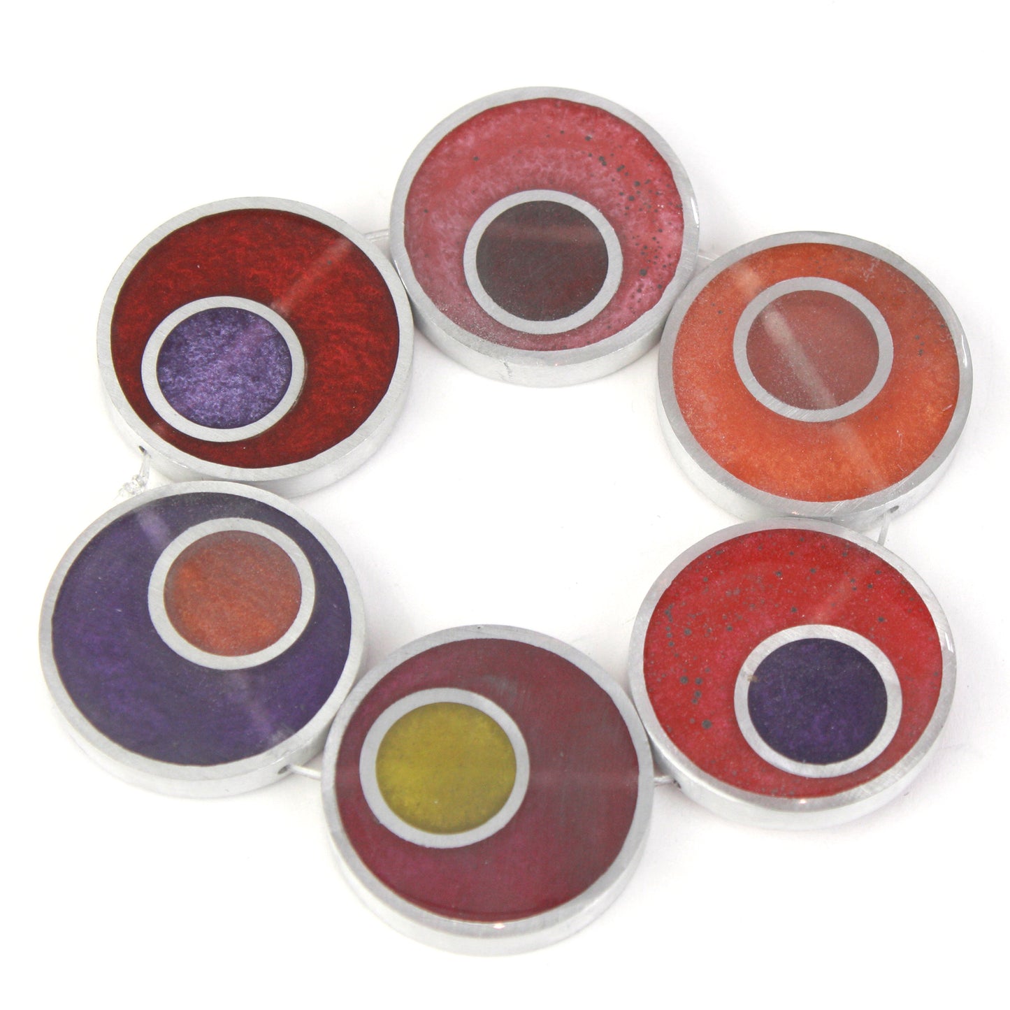 Resinique Double Circle Bracelet with warm tones of red, orange, and purple eco-resin layered in salvaged aluminum circles, strung on a flexible elastic band.