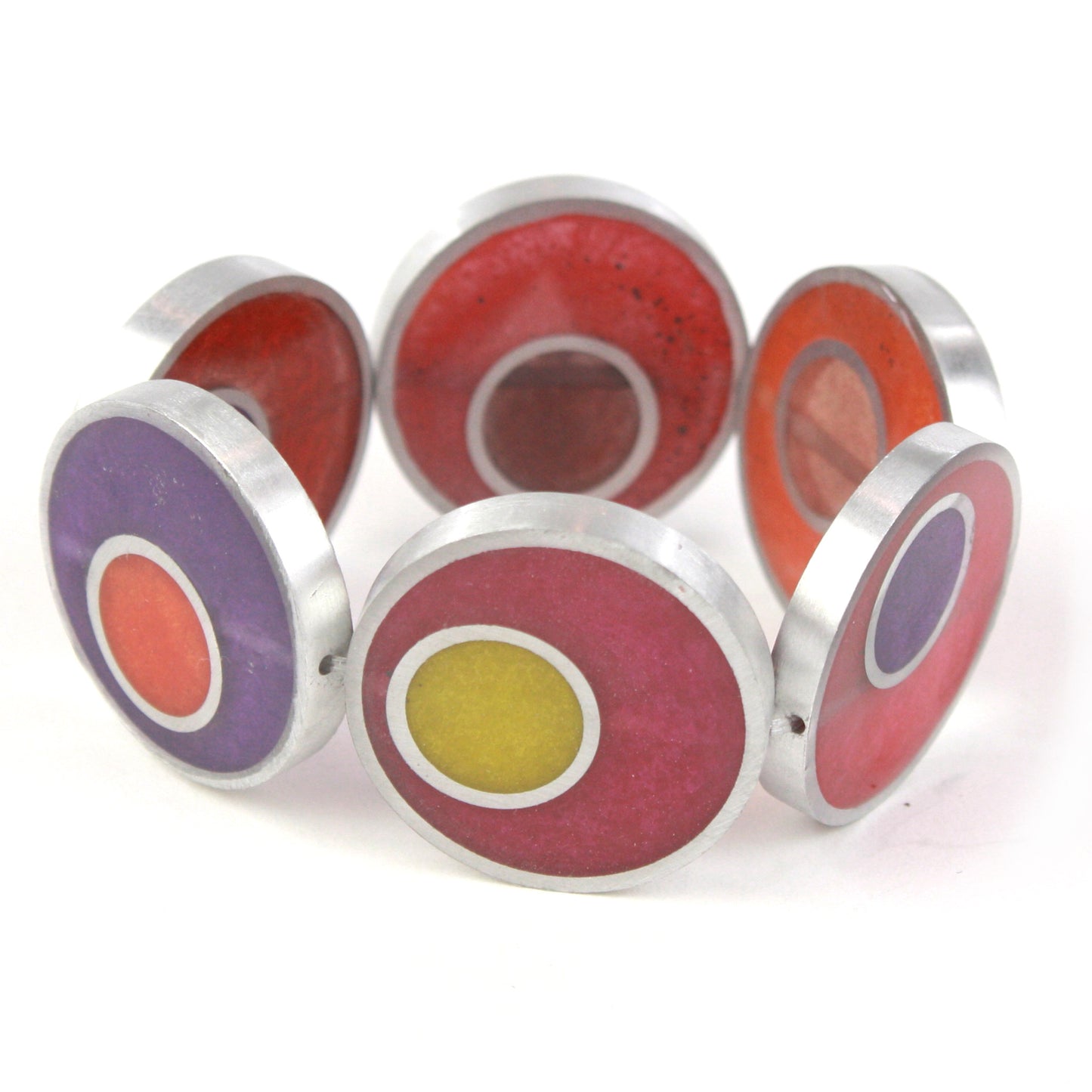 Resinique Double Circle Bracelet with warm tones of red, orange, and purple eco-resin layered in salvaged aluminum circles, strung on a flexible elastic band.