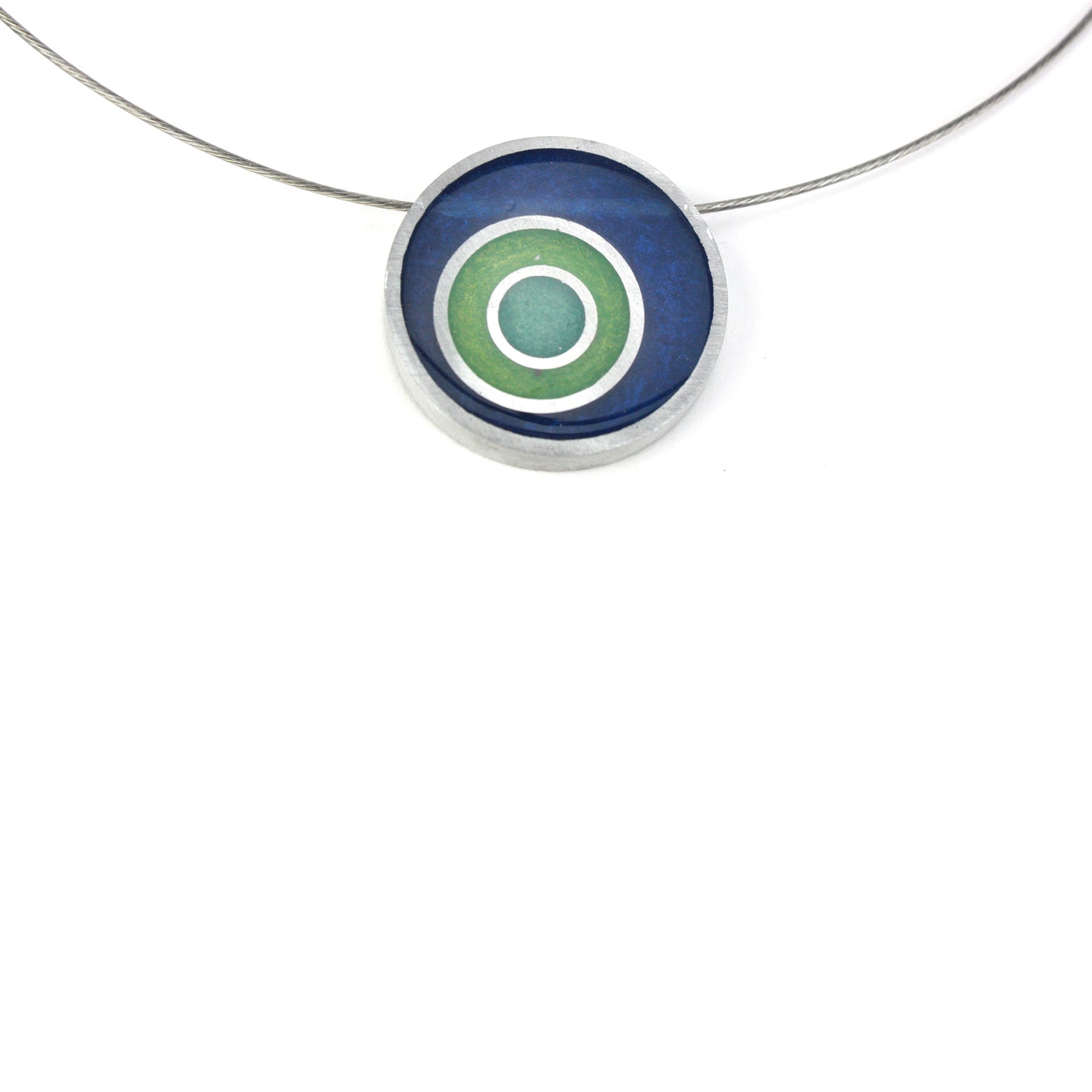Resinique triple circle necklace with a dark blue, seafoam, and turquoise concentric circle resin and salvaged aluminum pendant on a choker-length steel cord.