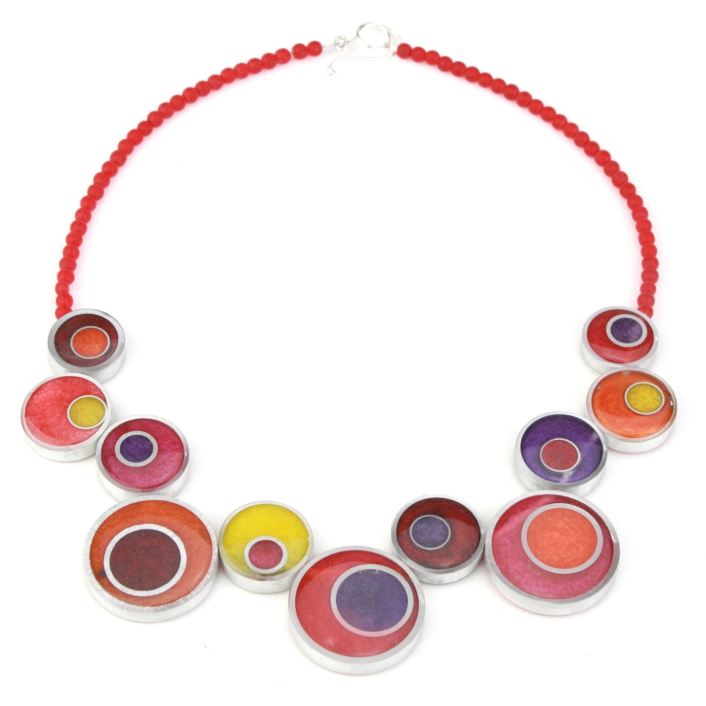A handcrafted offset necklace featuring eco-resin and salvaged aluminum beads in red, orange, yellow, and purple, strung on red glass beads with a silver clasp.
