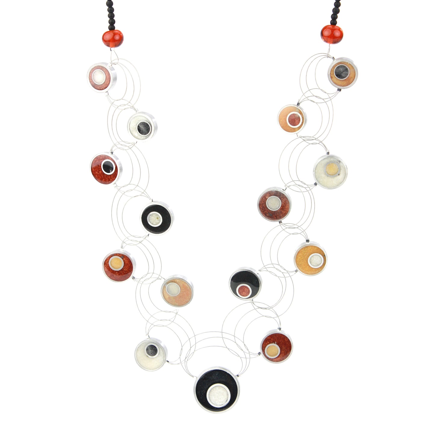 Resinique Interplay Necklace featuring intertwining steel cables with black, white, copper, and gold eco-resin circles and salvaged aluminum accents.