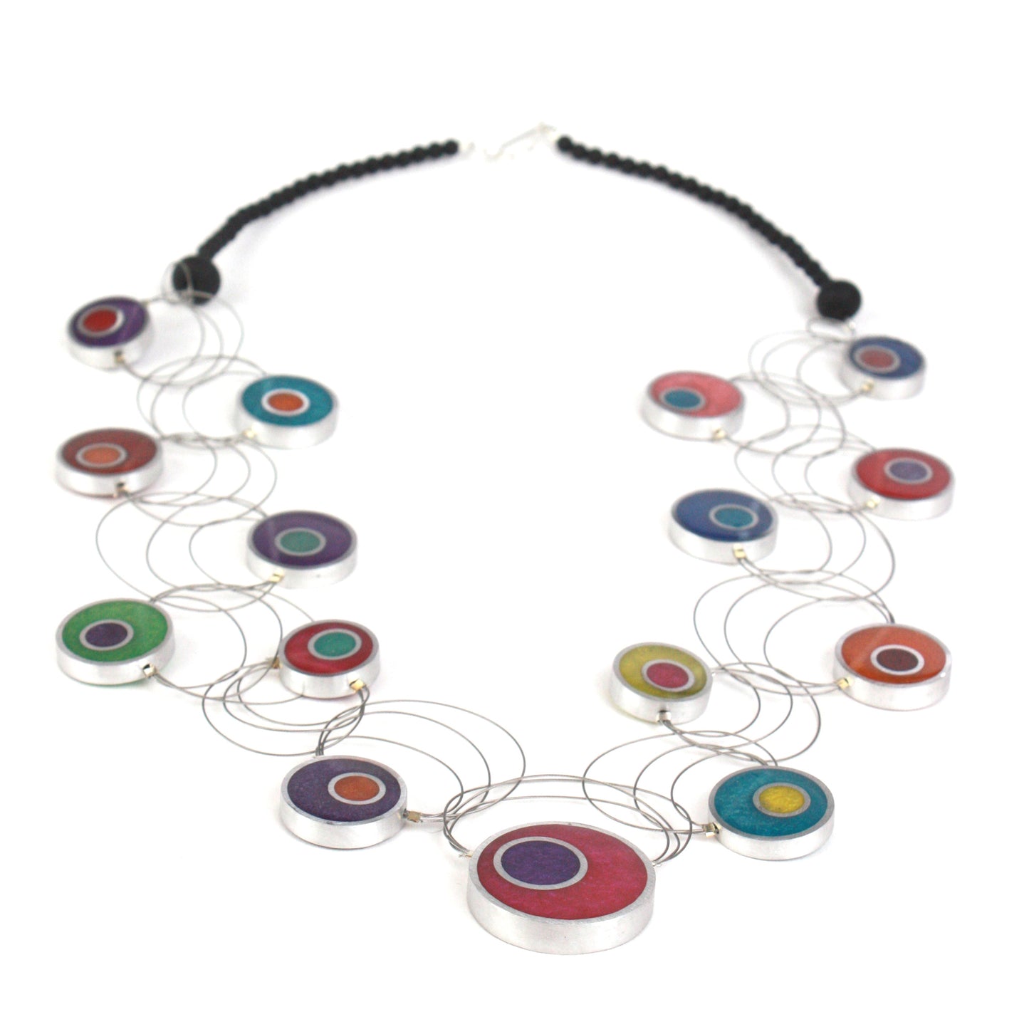 A handcrafted necklace with intertwining steel cables featuring multi-colored eco-resin and salvaged aluminum beads in vibrant shades of red, purple, green, blue, and orange.