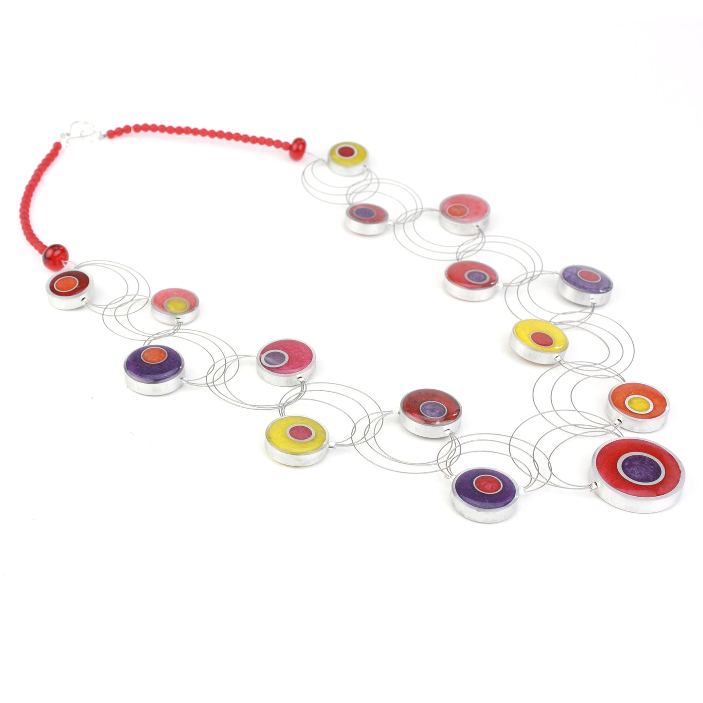 A handcrafted necklace featuring intertwining steel cables with eco-resin and salvaged aluminum beads in warm shades of red, orange, yellow, and purple.