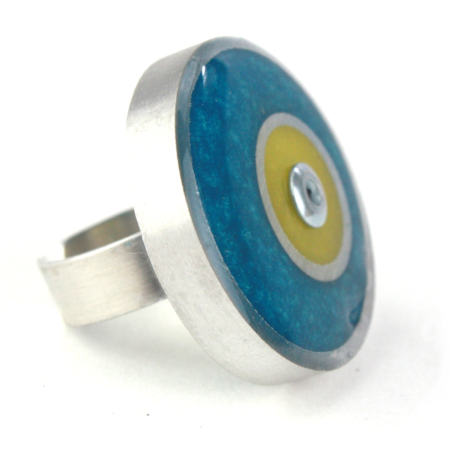 Teal and yellow Resinique Double Circle Ring crafted with eco-resin and salvaged aluminum, featuring a fully adjustable band for stylish comfort.