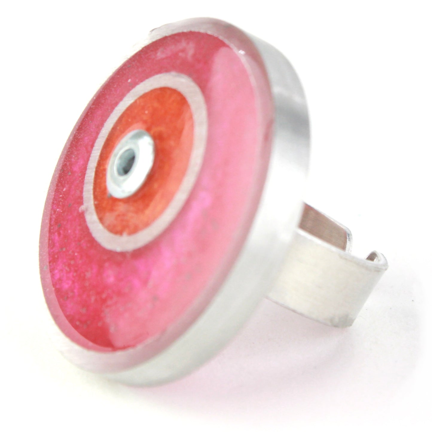 Bright pink and orange double circle ring made from salvaged aluminum and eco-resin with an adjustable band.