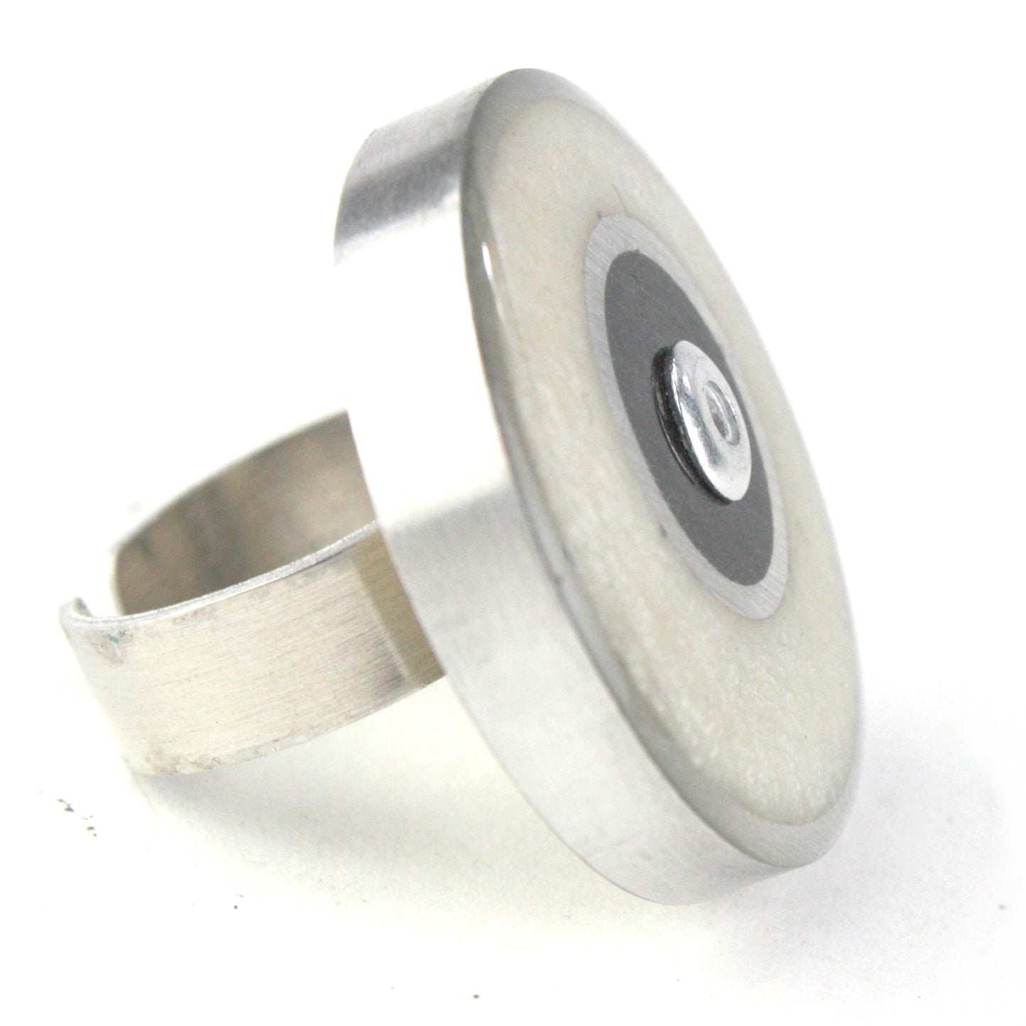 White and black Resinique Double Circle Ring crafted from eco-resin and salvaged aluminum, featuring an adjustable band for minimalist sustainable style.