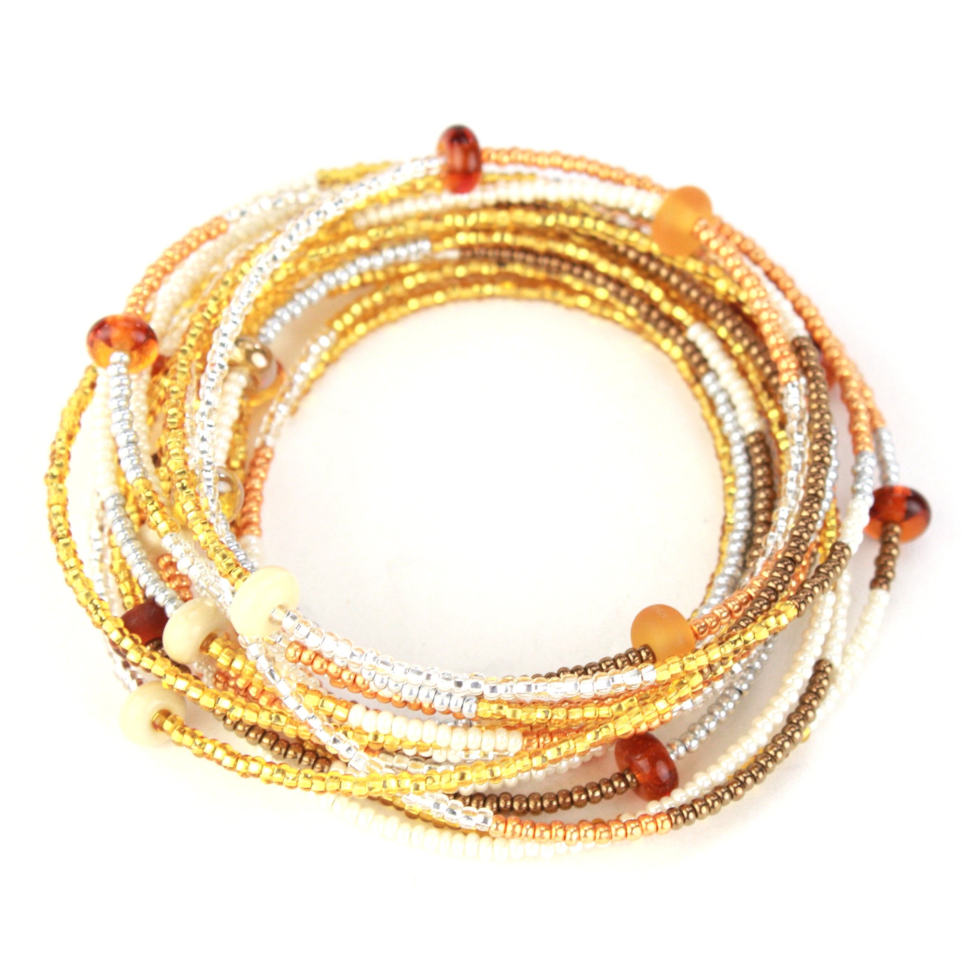 A 12-foot necklace crafted with tiny glass seed beads in warm golden, amber, and earthy tones, accented by handcrafted lampworked beads. Featuring a secure barrel screw clasp, this versatile piece can be styled as a layered necklace or wrapped around the wrist as a bracelet.
