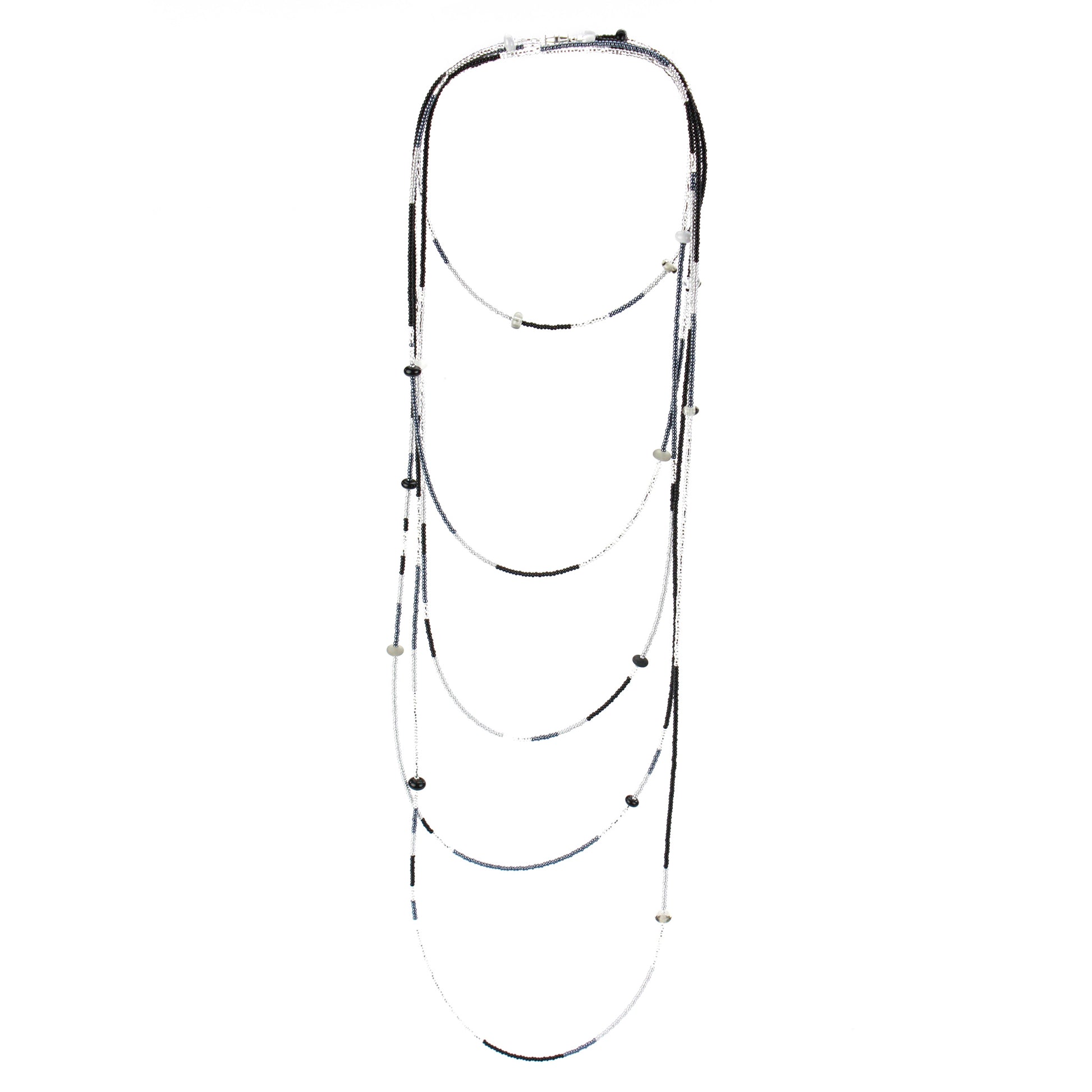 A long, multi-strand necklace featuring a mix of black, white, and silver glass seed beads, accented with handcrafted lampworked glass beads. The necklace is secured with a barrel screw clasp and offers a versatile, elegant design perfect for layering or wearing long.