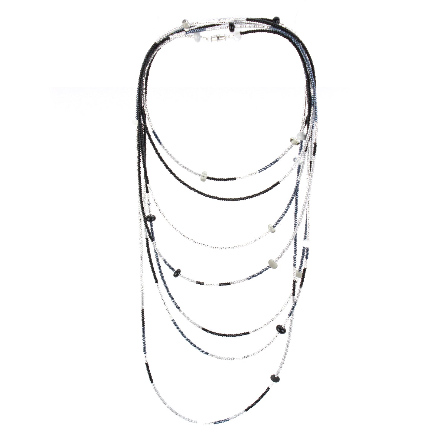 A long, multi-strand necklace featuring a mix of black, white, and silver glass seed beads, accented with handcrafted lampworked glass beads. The necklace is secured with a barrel screw clasp and offers a versatile, elegant design perfect for layering or wearing long.