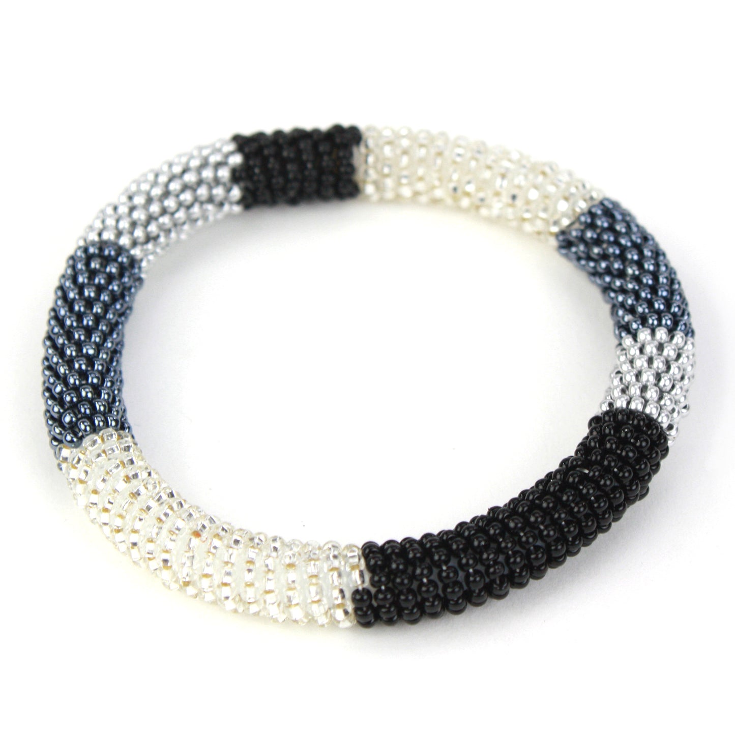 A sleek bangle bracelet made with tiny glass beads in black, silver, and white tones, wrapped around a flexible silicone core for easy slip-on wear.