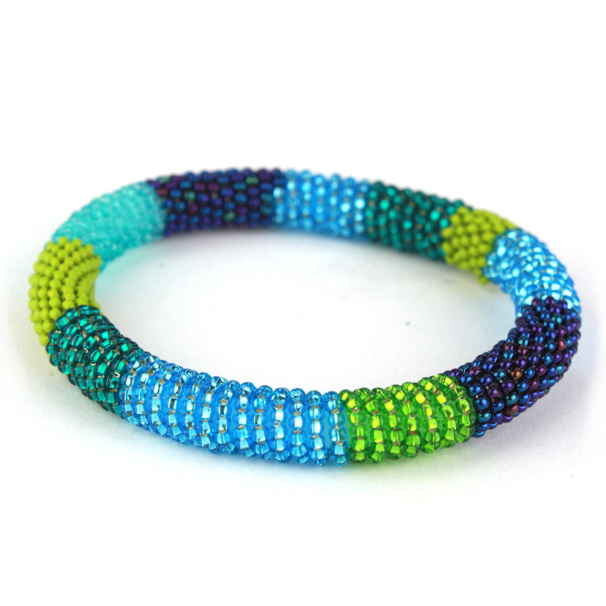 A vibrant bangle bracelet featuring tiny glass beads in shades of blue, teal, green, and purple, wrapped around a flexible silicone core for easy slip-on wear.
