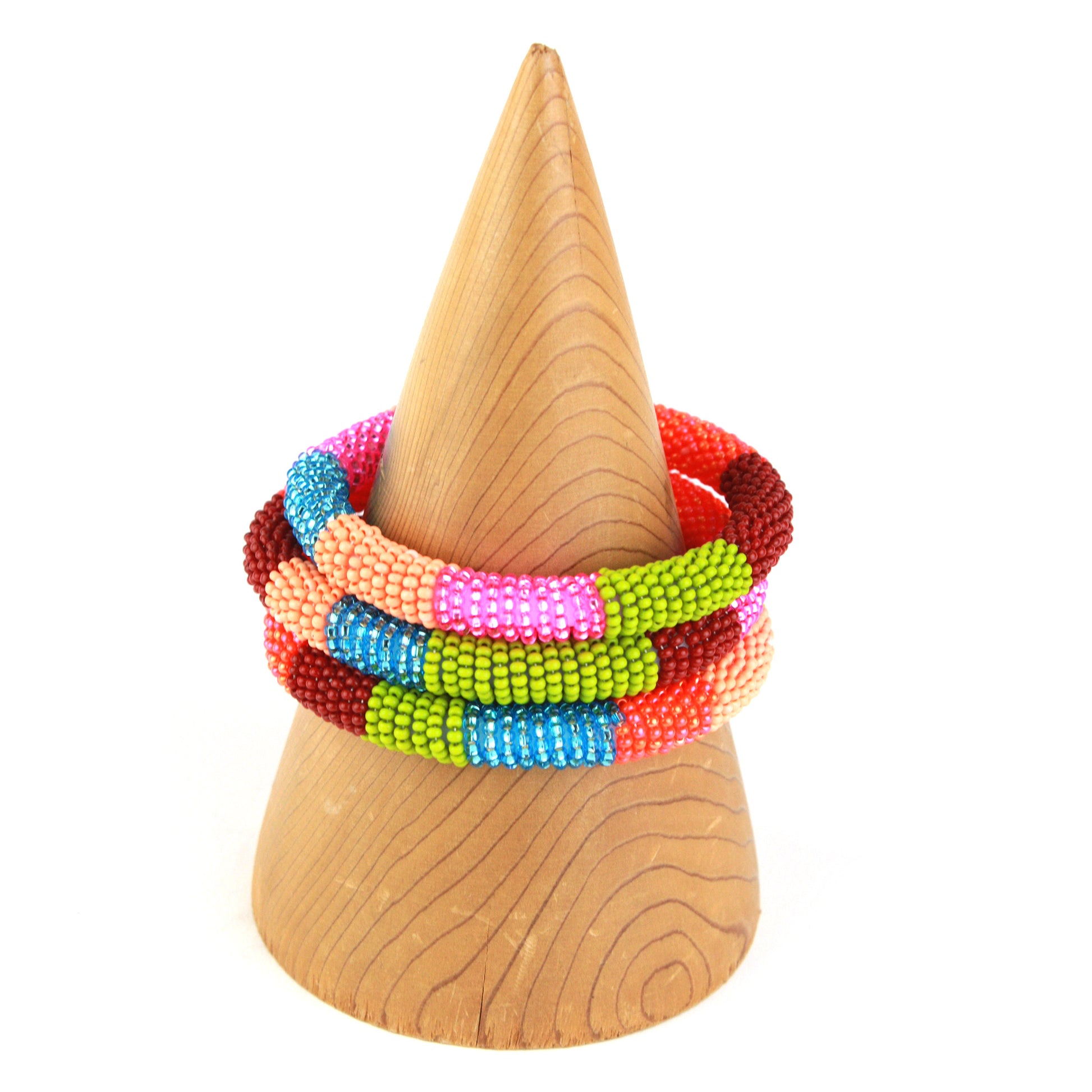 A colorful bangle bracelet featuring tiny glass beads in bold shades of pink, blue, orange, green, and red, wrapped around a flexible silicone core for easy wear.