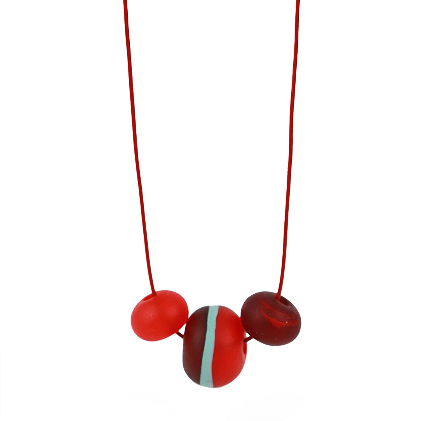 Soft Stripes Necklace with three hand-blown sandblasted glass beads in red, orange, and blue, strung on an adjustable fine leather cord.