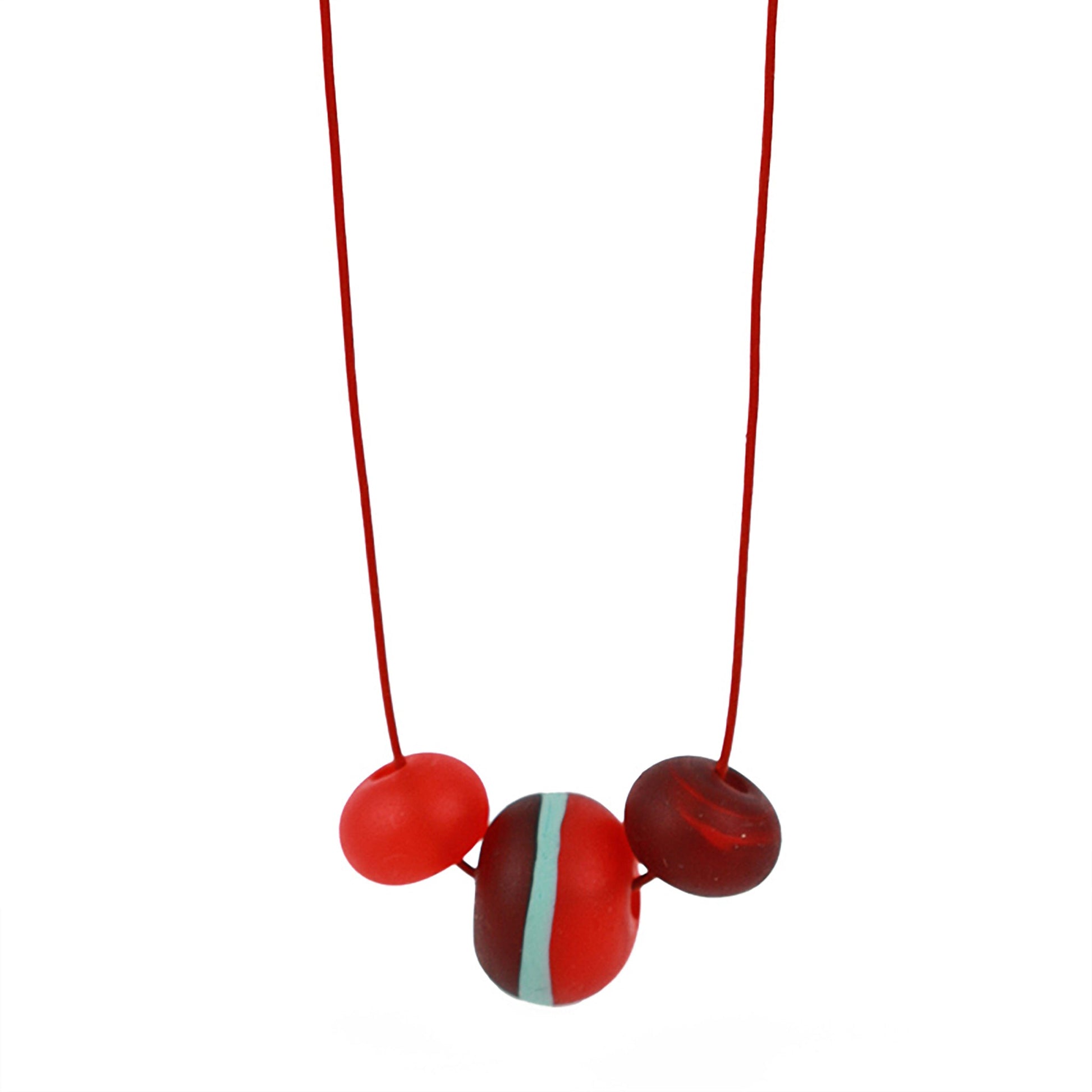 Soft Stripes Necklace with three hand-blown sandblasted glass beads in red, orange, and blue, strung on an adjustable fine leather cord.