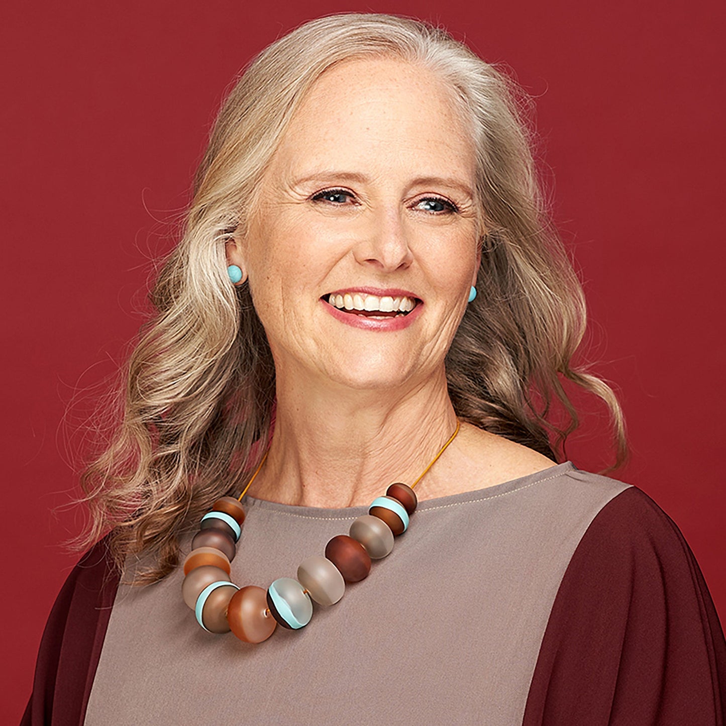 Soft Stripes Necklace with hand-blown sandblasted glass beads in white, grey, amber, and blue hues, strung on an adjustable fine leather cord.