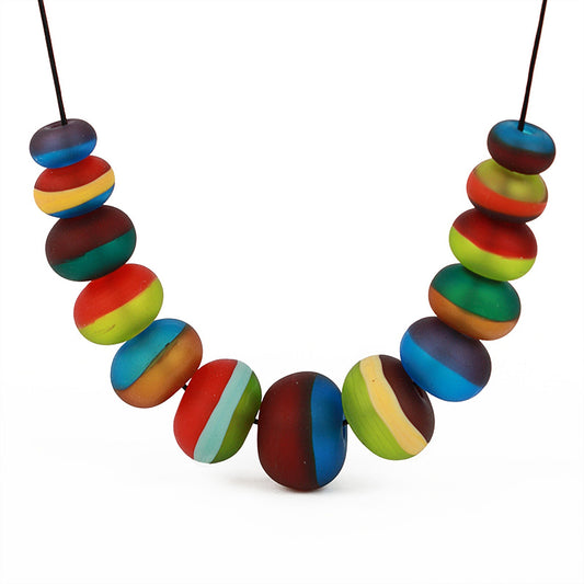 Soft Stripes Necklace with hand-blown sandblasted glass beads in multicolored hues, strung on an adjustable fine leather cord.