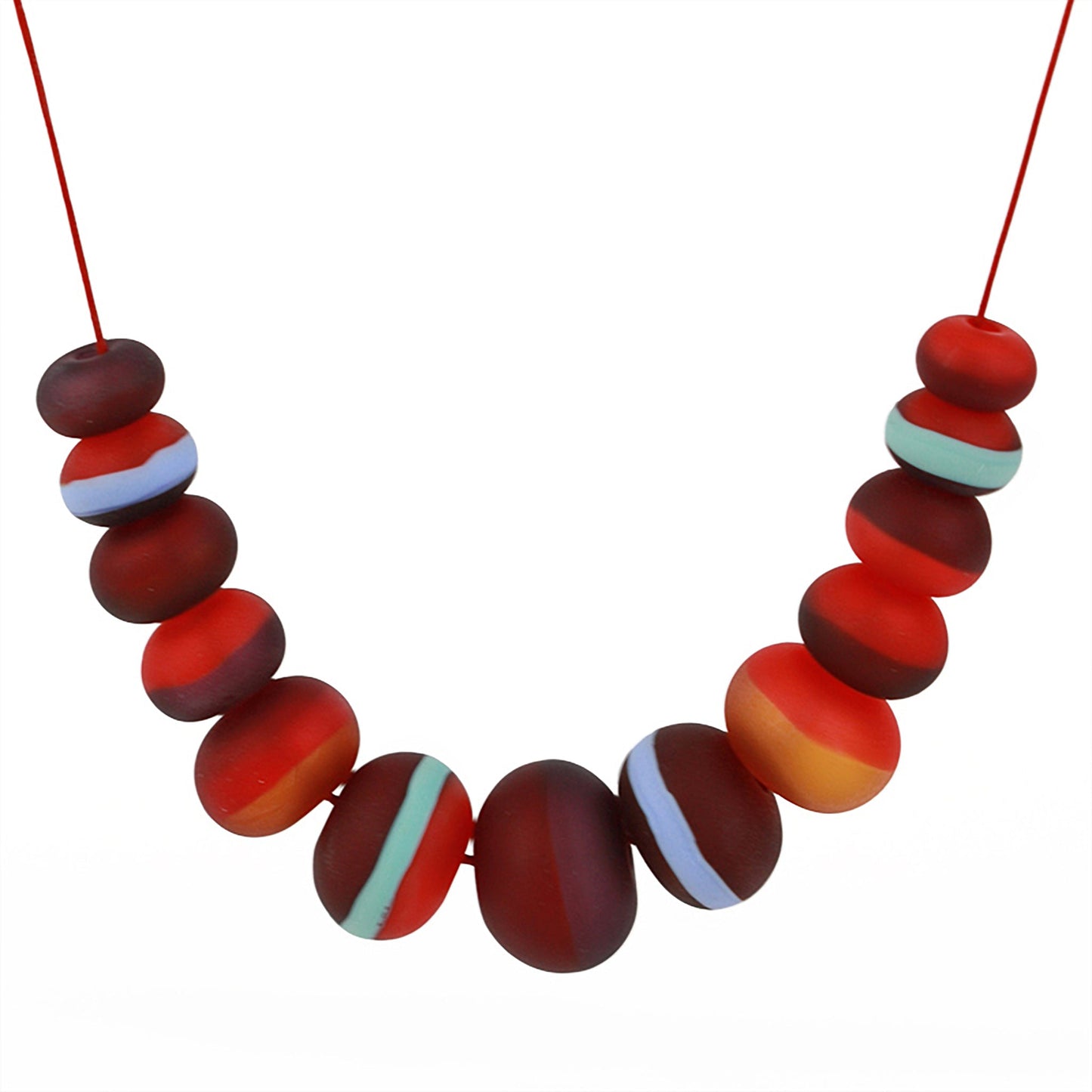 Soft Stripes Necklace with hand-blown sandblasted glass beads in red, orange, and blue hues, strung on an adjustable fine leather cord.
