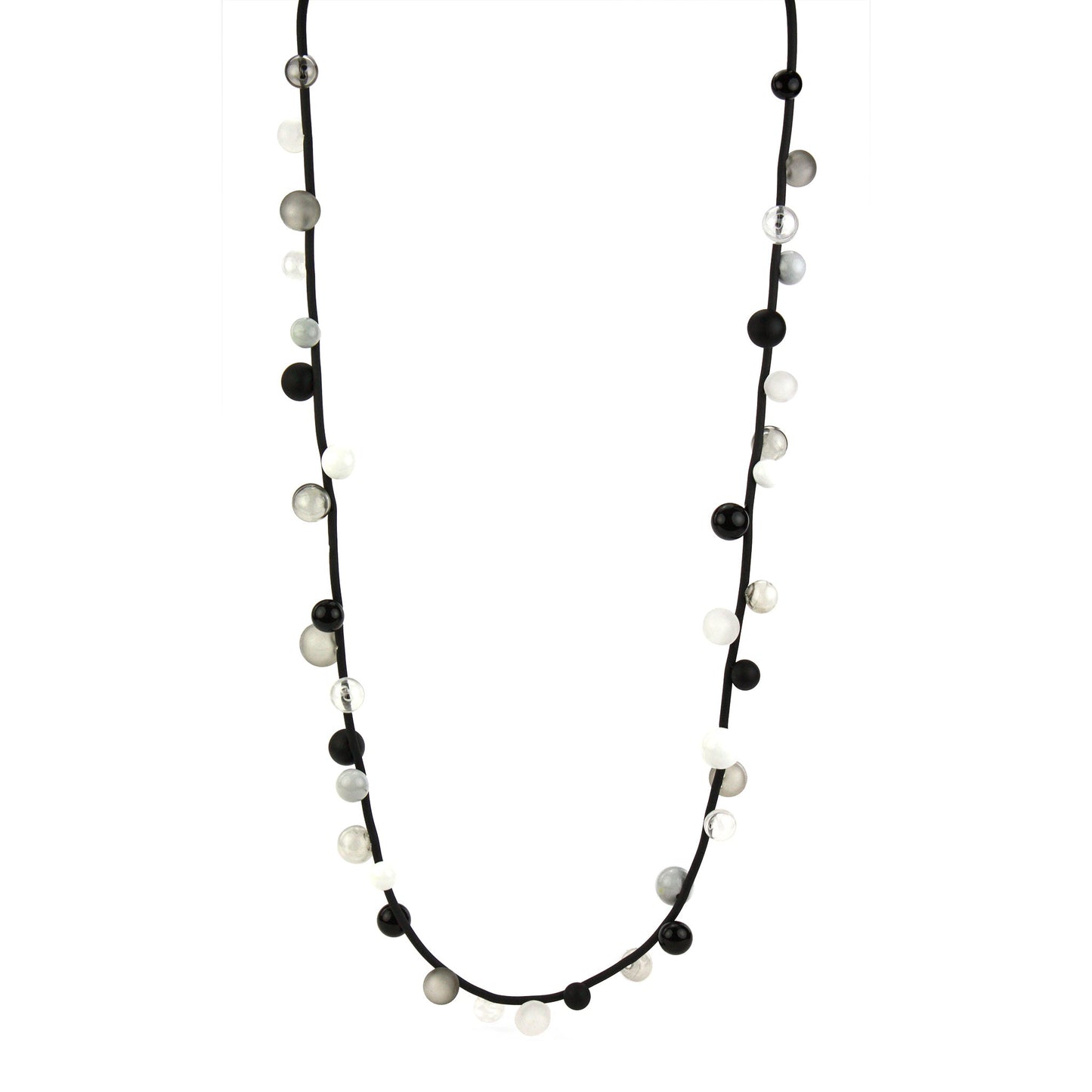 "Bolla" necklace featuring monochrome hand-blown glass beads in black, white, and clear shades, strung on a steel cable with a rubber cord, worn long or doubled.