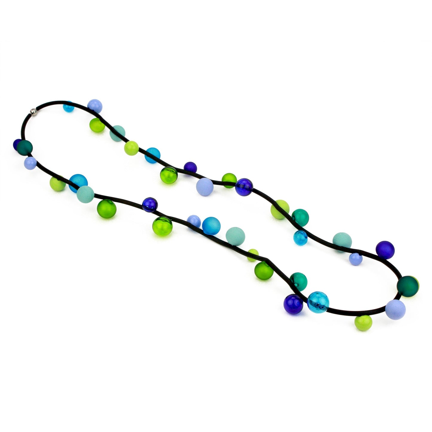 The "Bolla" necklace featuring hand-blown glass beads in shades of blue, green, and teal, strung on a steel cable threaded through a rubber cord, worn long or doubled.