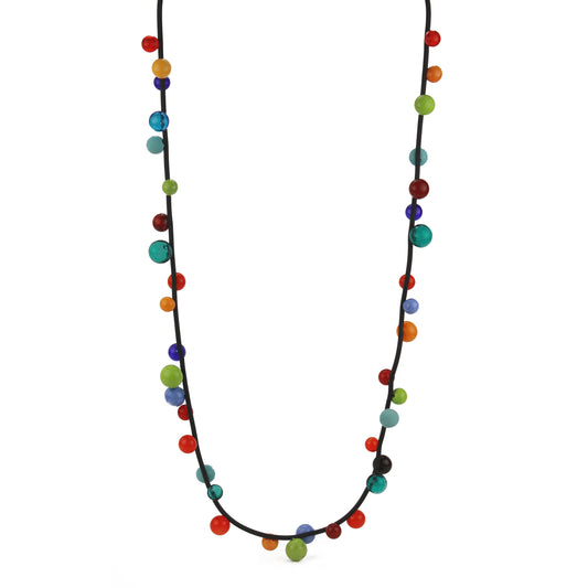 "Bolla" necklace featuring vibrant hand-blown glass beads in rainbow colors, strung on a steel cable threaded through a rubber cord, worn long or doubled.
