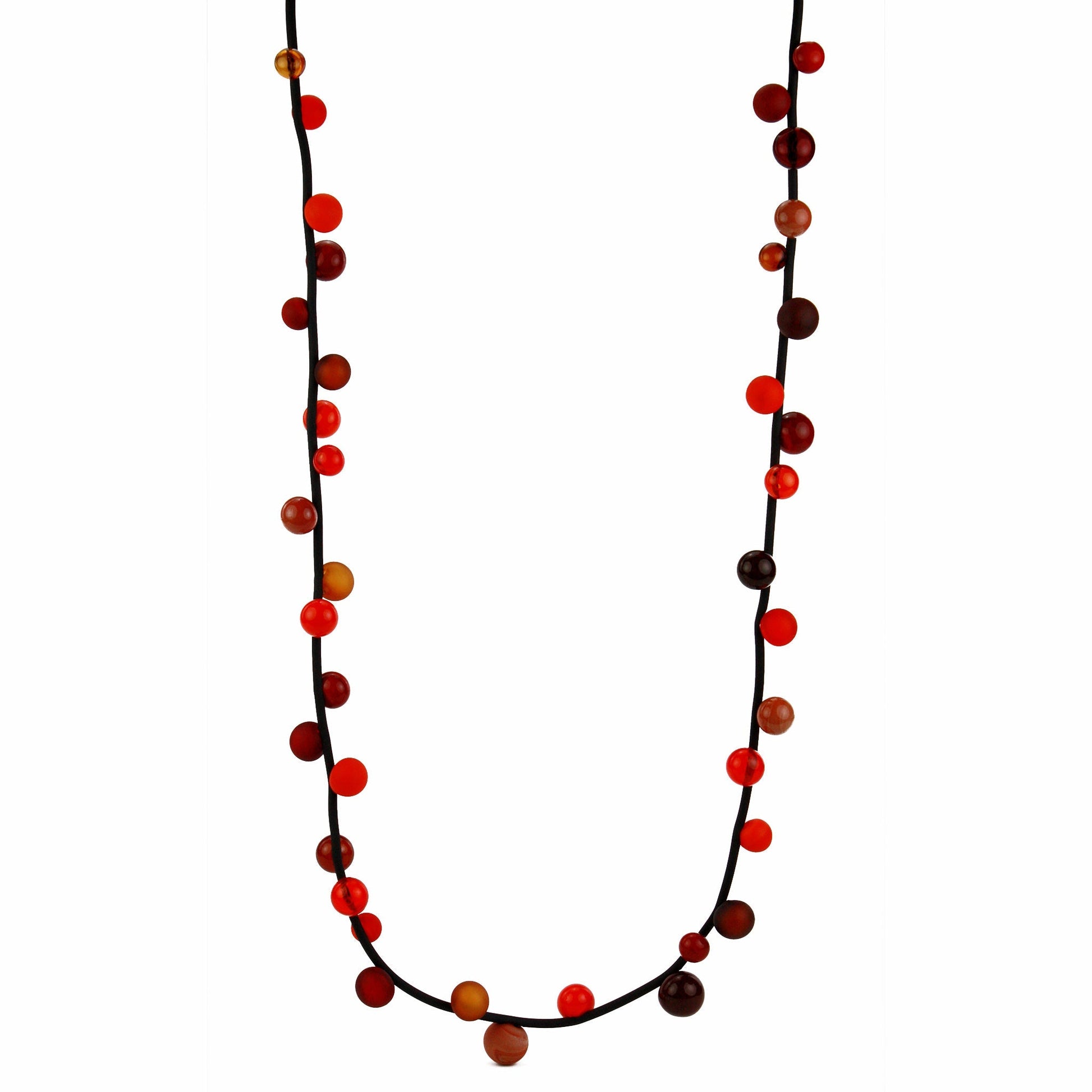 "Bolla" necklace with hand-blown glass beads in red, orange, and amber tones, strung on a steel cable within a rubber cord, shown in a long style.