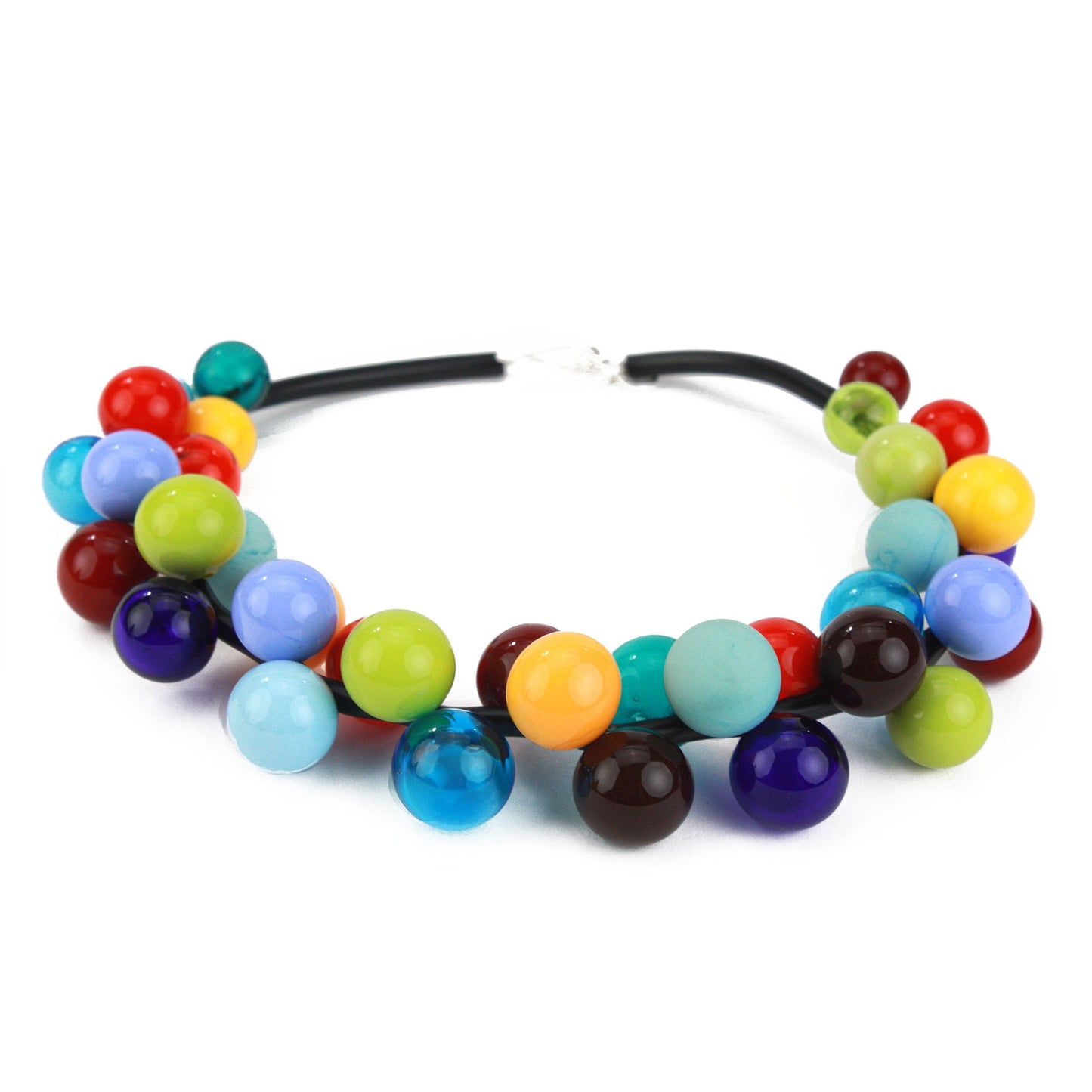 The "Bolla" necklace featuring vibrant hand-blown glass beads in rainbow hues, strung on steel cable through a rubber cord with a sterling silver clasp.