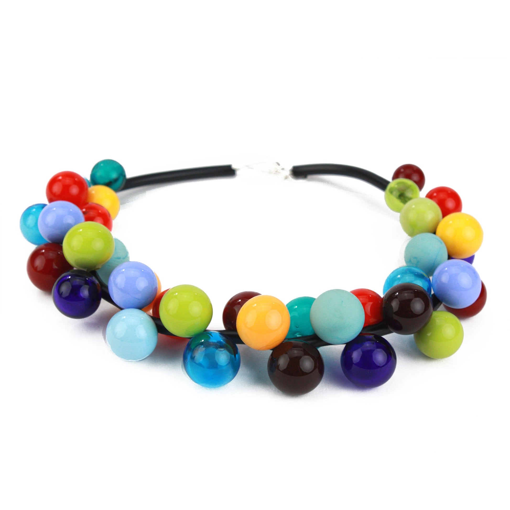 The "Bolla" necklace featuring vibrant hand-blown glass beads in rainbow hues, strung on steel cable through a rubber cord with a sterling silver clasp.