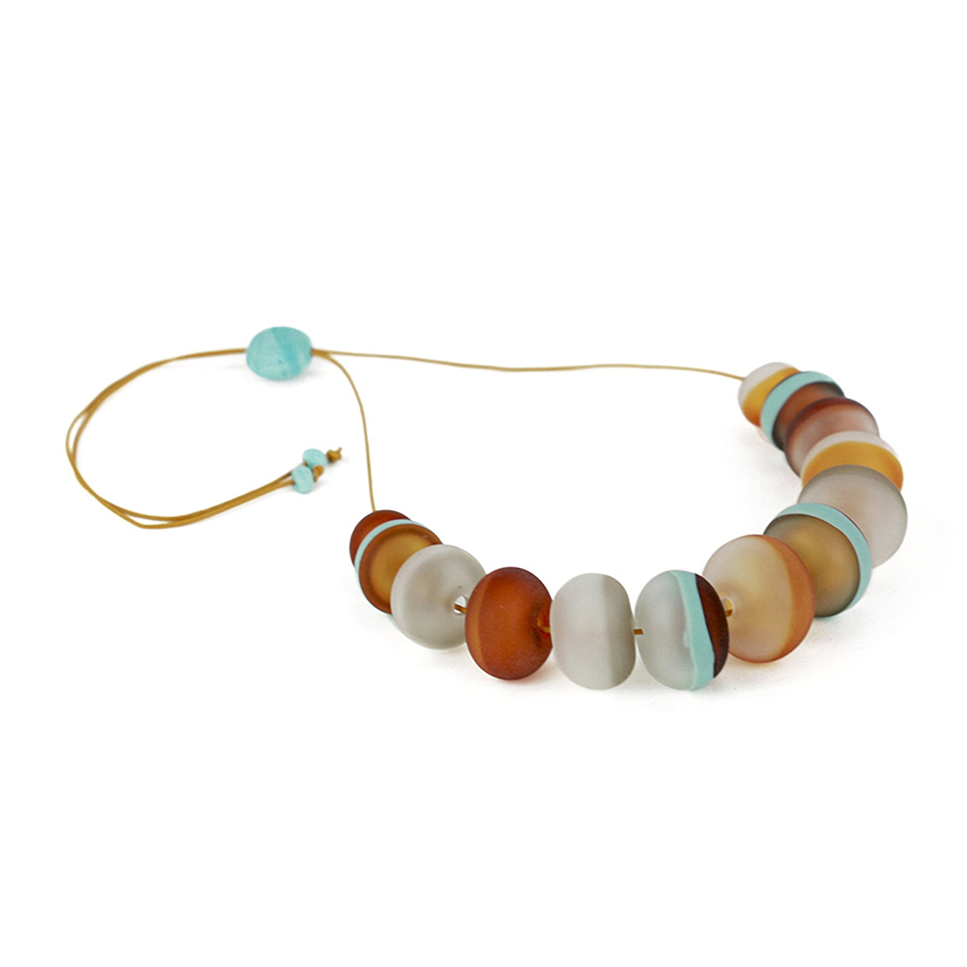 Soft Stripes Necklace with hand-blown sandblasted glass beads in white, grey, amber, and blue hues, strung on an adjustable fine leather cord.
