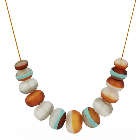 Soft Stripes Necklace with hand-blown sandblasted glass beads in white, grey, amber, and blue hues, strung on an adjustable fine leather cord.