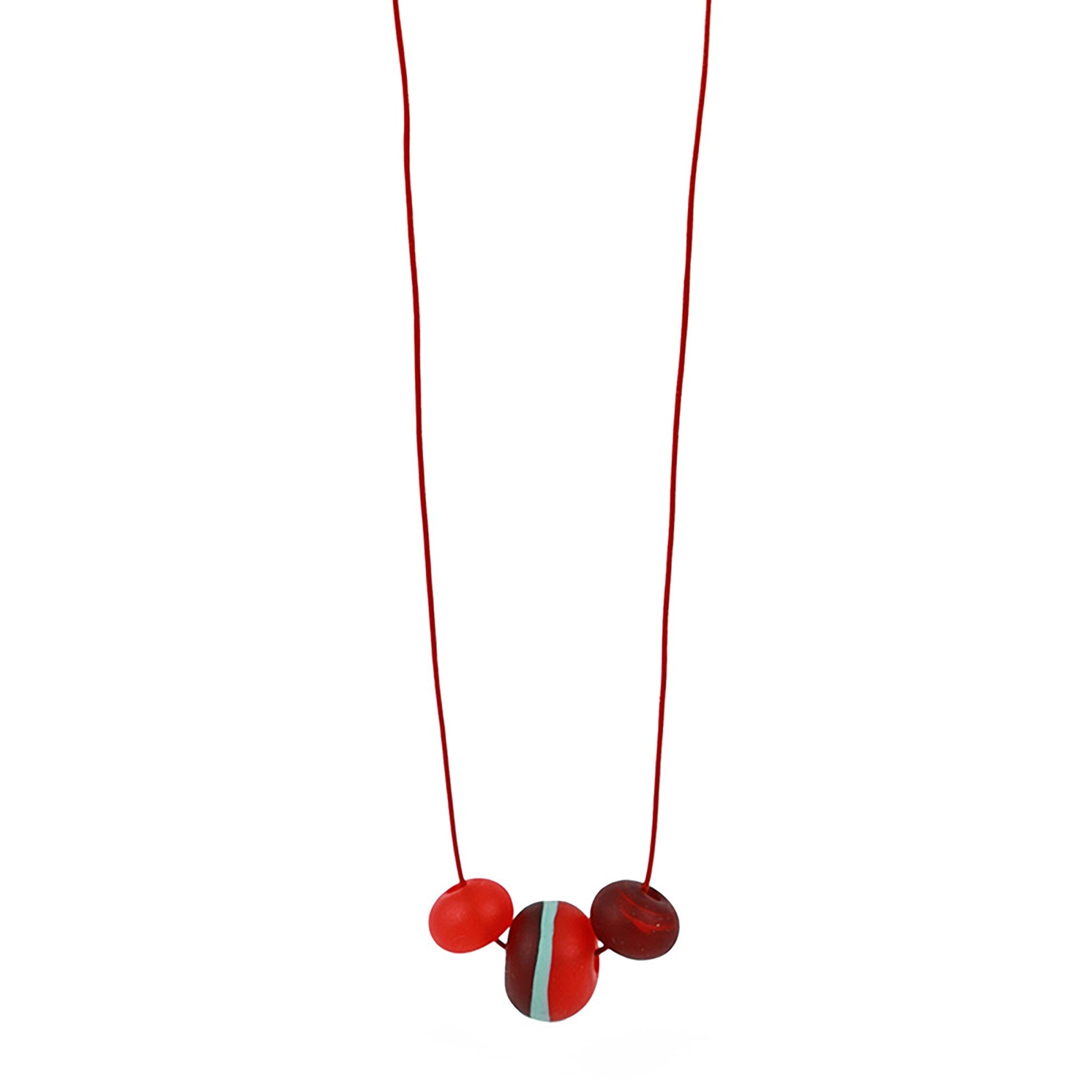 Soft Stripes Necklace with three hand-blown sandblasted glass beads in red, orange, and blue, strung on an adjustable fine leather cord.