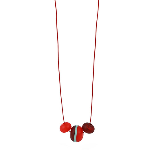 Soft Stripes Necklace with three hand-blown sandblasted glass beads in red, orange, and blue, strung on an adjustable fine leather cord.