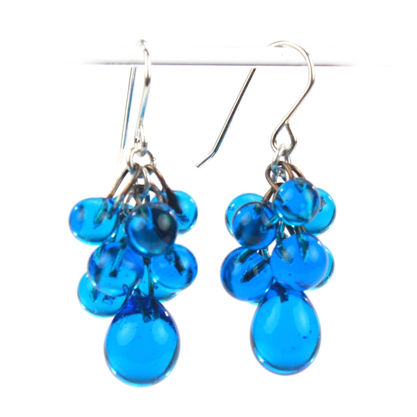 Aqua Cluster Earrings featuring vibrant aquamarine glass beads in a cascading design with teardrop accents and sterling silver ear wires for a bold statement.