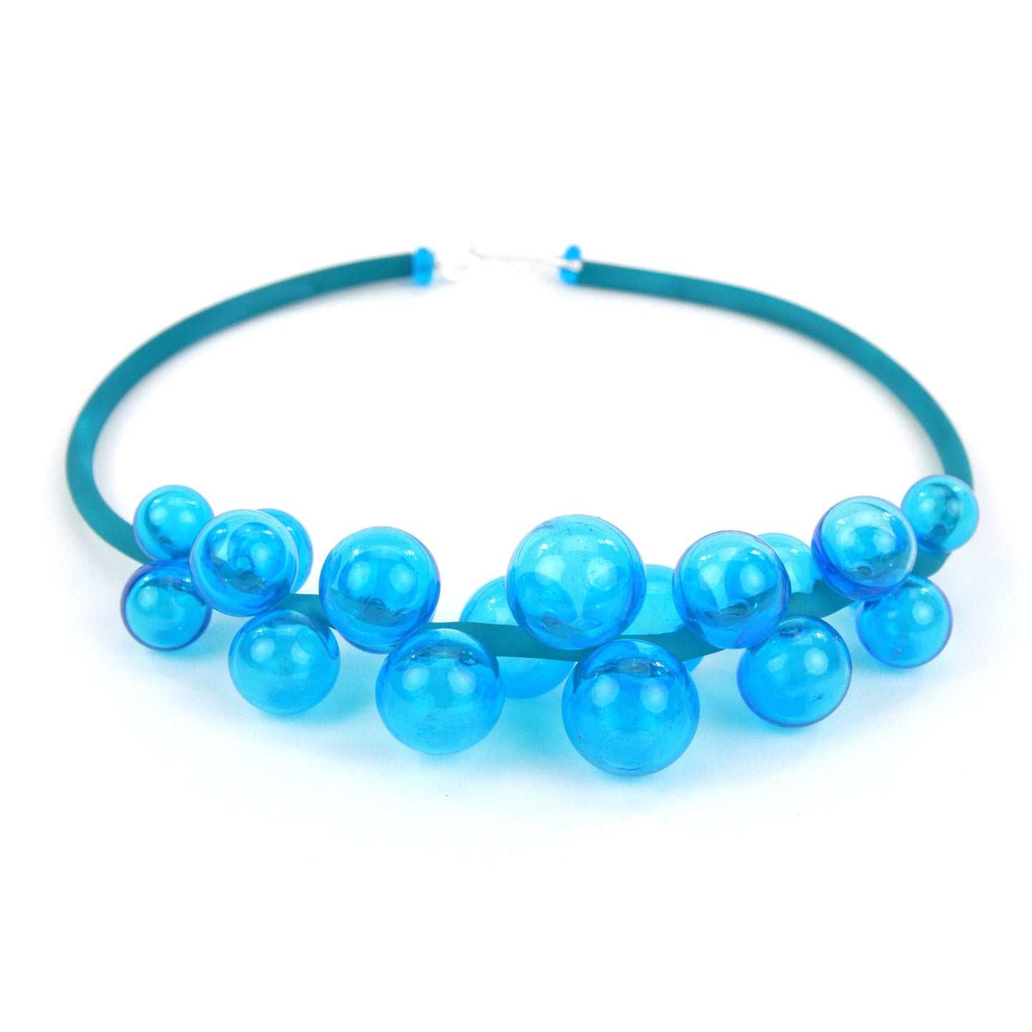A vibrant aqua Chroma necklace featuring a cluster of handmade glass beads strung on steel and threaded through a hand-dyed silicone cord with a sterling silver clasp.